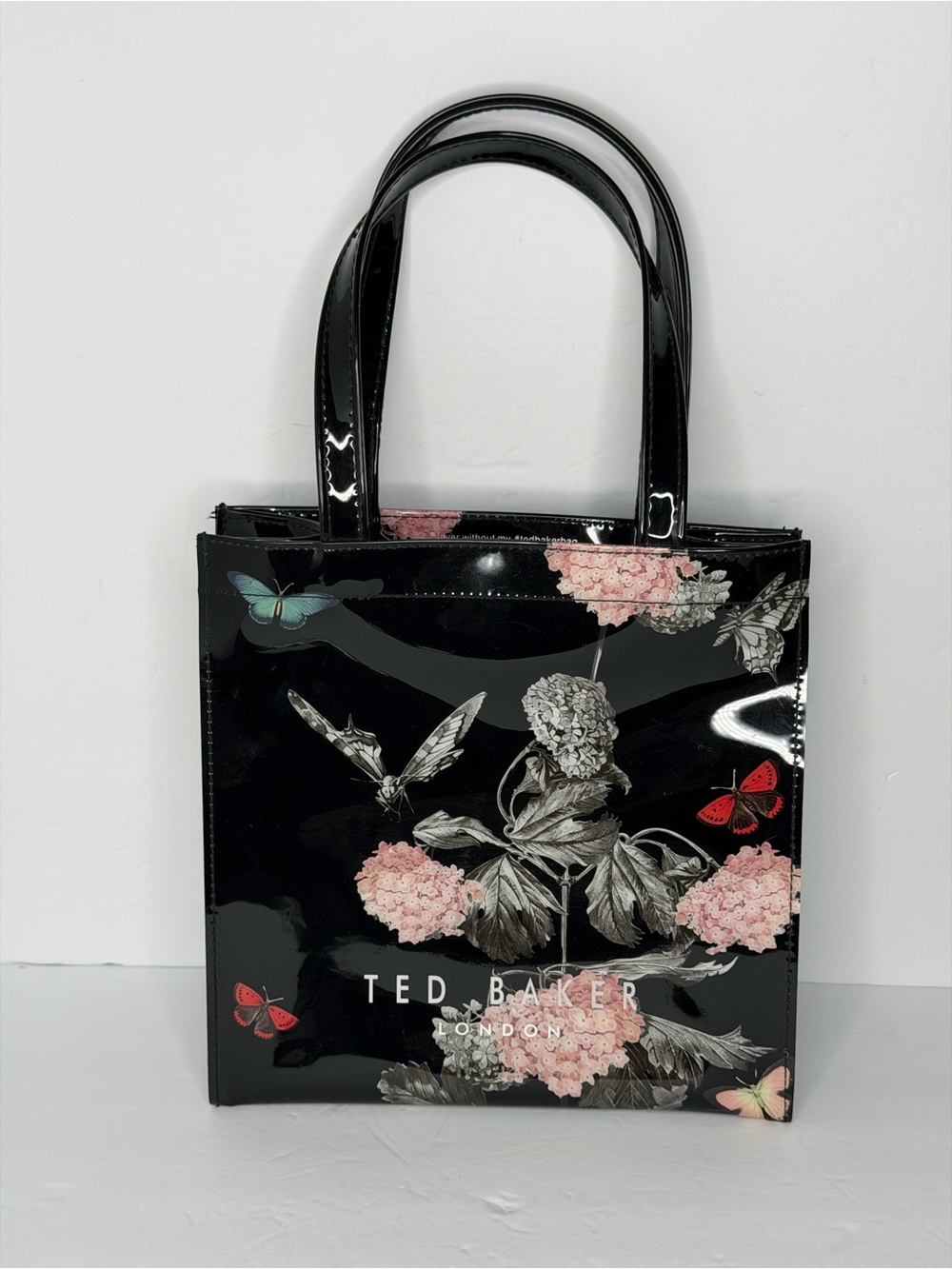 Ted Baker London Black Floral and Butterfly glossy Polyvinyl small Tote Bag